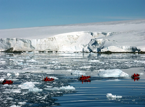Polar circle boats ploughing through the ice,Antarctica.