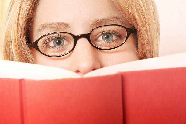 istock Blonde girl reading a book 115881307