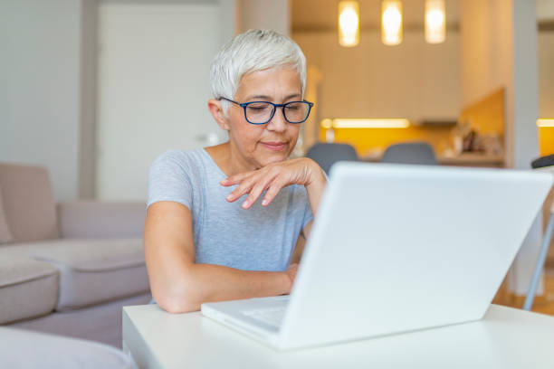istock Middle-aged woman working from home on laptop. 1158815269