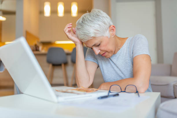 Senior woman working on home finance.
