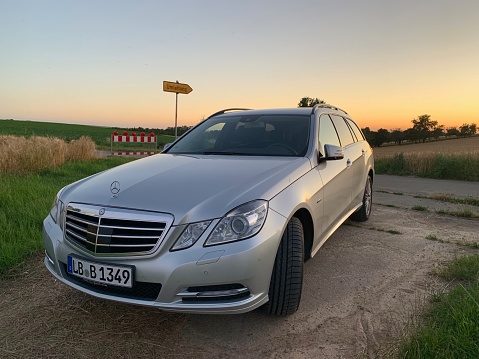 Steinheim, Germany - June, 27 2019: Mercedes Benz E-Class T in rural fields at sunset.