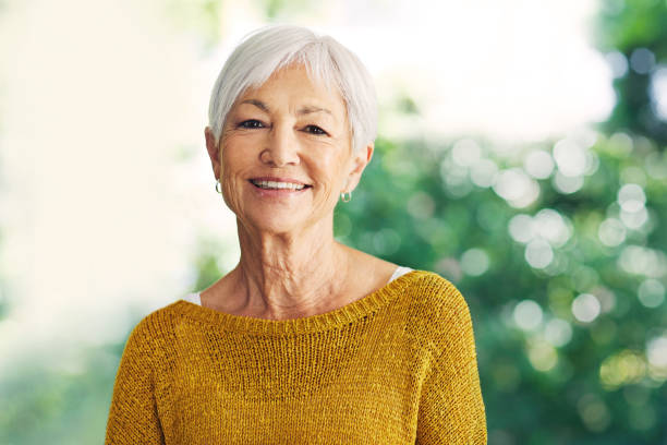 The grey years are the good years Shot of a confident senior woman standing in her home white hair photos stock pictures, royalty-free photos & images