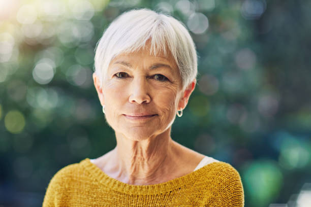 Content with the quality of my life Shot of a confident senior woman standing outdoors serious stock pictures, royalty-free photos & images