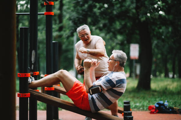 istock Active seniors exercising together in nature 1158818038