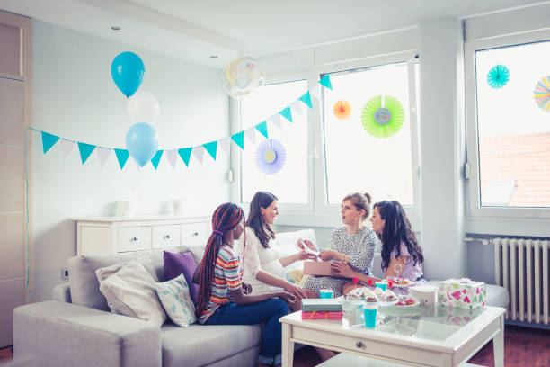 Baby shower party girls Girlfriends enjoying their time on baby shower party cute pregnant woman with gift stock pictures, royalty-free photos & images