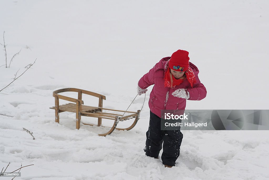 Winter fun A little girl pulling her sled Activity Stock Photo