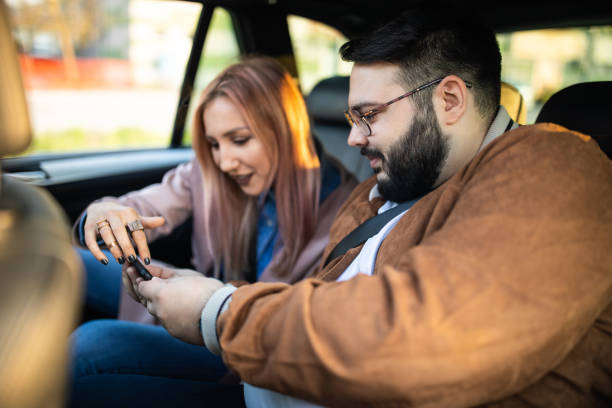 istock Friends searching maps for direction on phone in a car 1158819365