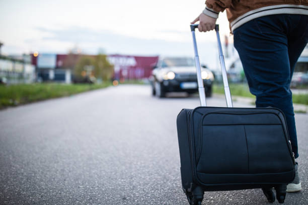 istock Man pulling luggage on the street 1158819406