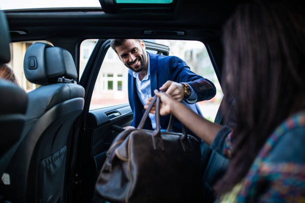 istock Smiling man entering ride sharing car 1158819424