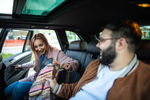 istock Young  woman entering a car while friends waiting her 1158819954