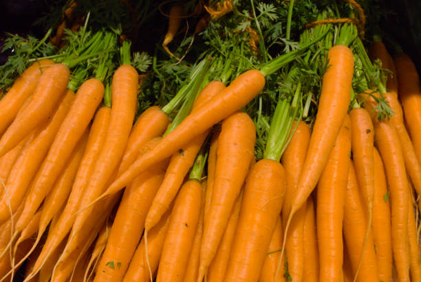 istock stack of orange carrots in the supermarket 1158821511