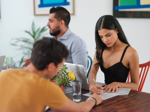 istock Young woman writing down ideas during a meeting 1158821923