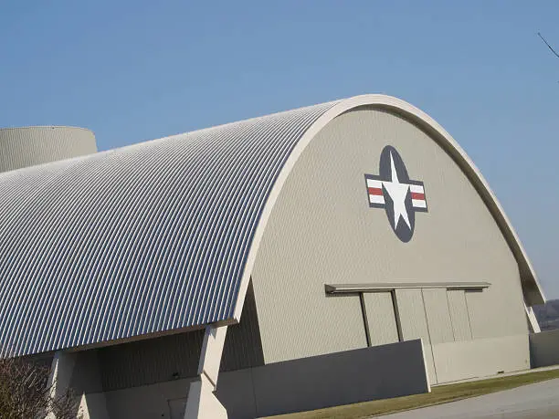 Side view of an Air Force hanger with doors closed and insigia visible.