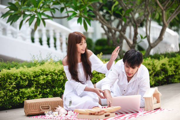 istock Happy Romantic Couples lover talking and drinking wine while having a picnic at home 1158824296