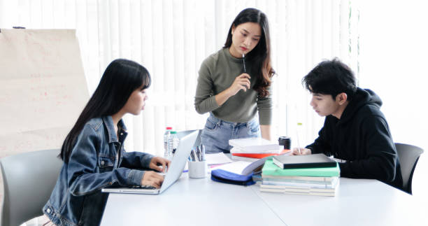 istock Group Students Smile and have fun and using tablet It also helps to share ideas in the work and project. And also review the book before the exam 1158824309