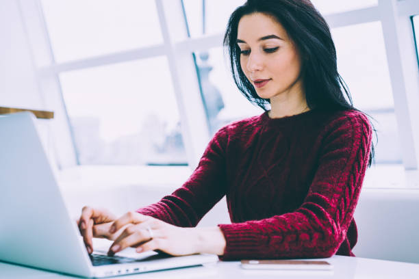 istock Beautiful copywriter working freelance at modern laptop device typing text information on keyboard.Charming brunette female searching information on internet websites via wireless 4G connection 1158824459