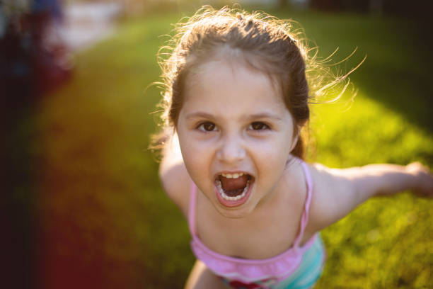 istock Playful child in swimsuit shouting in a back yard 1158825787