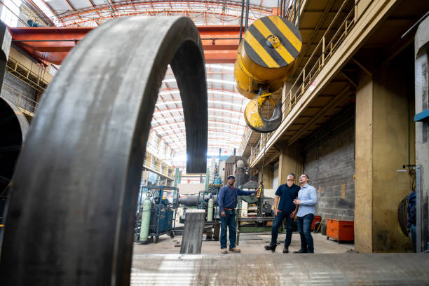 istock Workers operating a machine at a metallurgy factory 1158830301