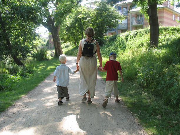 Grandmother and her grandson walking under cherry trees