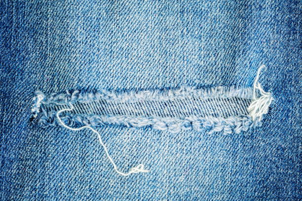 istock Cut Knee Hole in Jeans 1158832368