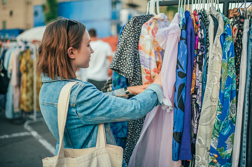 Teenager choosing clothes at a flea market