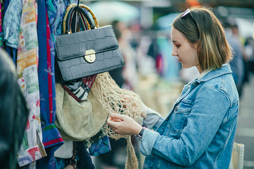 Teenager choosing clothes at a flea market