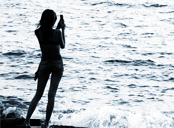 istock silhouette of woman with cellphone 115883706