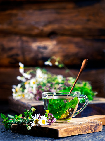 A the cup of lemon balm tea on the wooden table