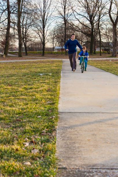 istock Little boy learning to ride a bike 1158839297