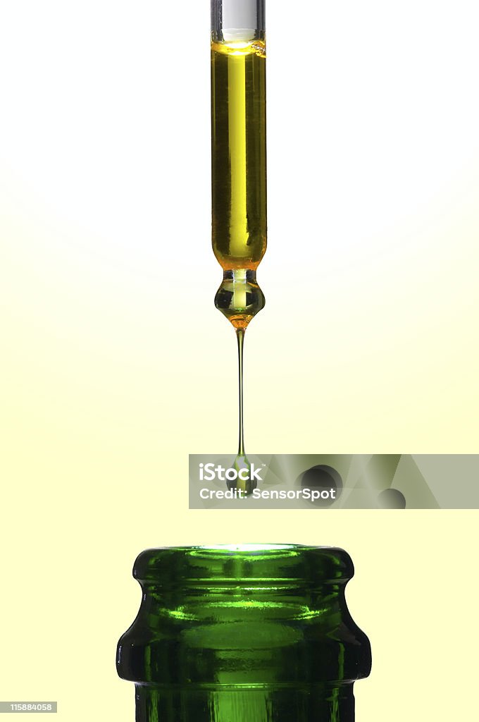 Pure olive oil Precious olive oil like liquid gold falling into a bottle. Cooking Oil Stock Photo