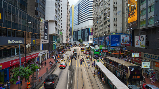 People walking across Hennessy Road Causeway Bay and shopping in Central road in hong kong and travel by tram and train in famaus place in hongkong