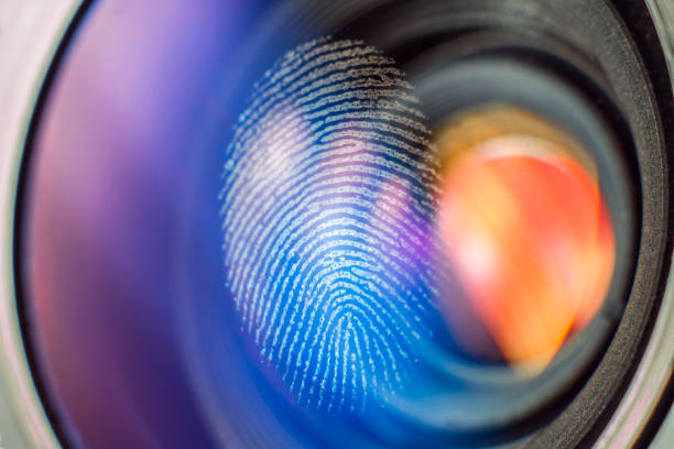 Fingerprint on a camera lens. Investigation, biometrics and security concept.