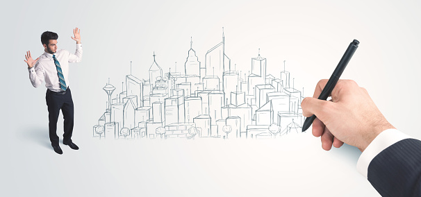 Businessman looking at hand drawn city on wall concept on background