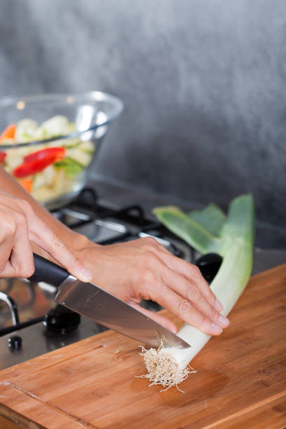 istock cutting leeks on a wooden board 1158844514