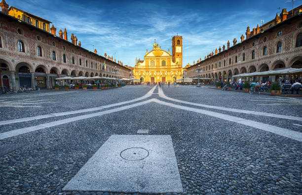 View of Ducale square with Ambrogio church in Vigevano at sunset,  Pavia province, Italy. stock photo