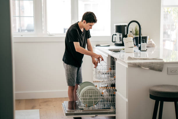 istock Teenager Helping Wash Dishes 1158847506