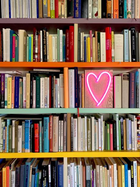 istock Books shelves packed with books and a neon heart shape 1158847670