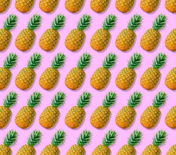 istock Rows Of Pineapple On Pink Background 1158849373
