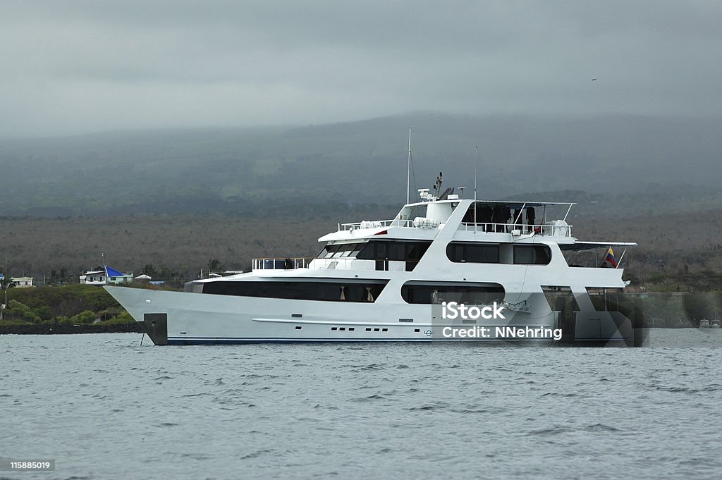 cruise yacht Yacht at anchor. Used for tours. Puerto Ayora, Isla Santa Cruz, Galapagos Islands, Ecuador. The Galapagos Islands are a UNESCO World Heritage Site. Anchored Stock Photo