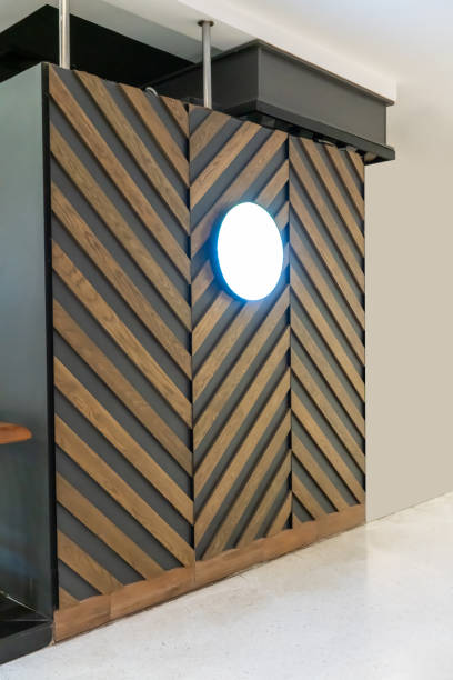 istock Blank round signboard hanging against wood pattern background. Interior design detail. 1158850220
