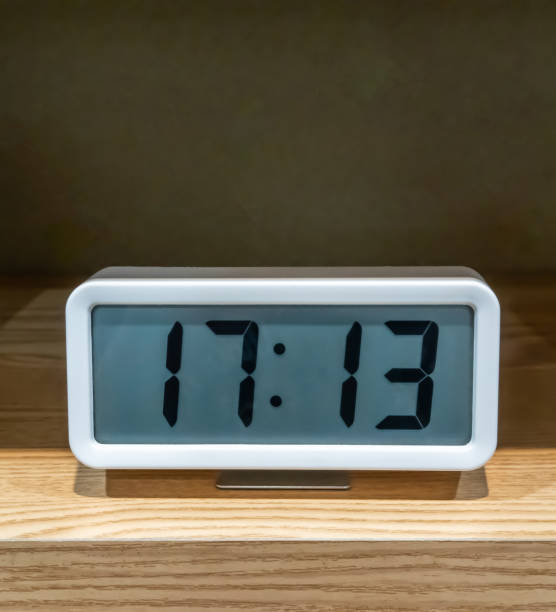 istock White pocket digital clock on wooden shelf for decoration 1158850229
