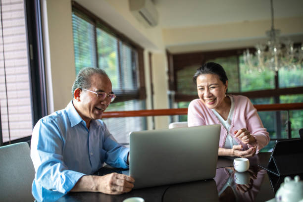 istock Senior couple having video call on laptop 1158850542