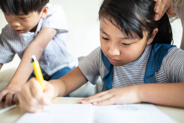 istock Brother and sister drawing at home 1158850565