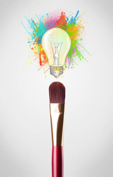 istock Brush close-up with colored paint splashes and lightbulb 1158850665