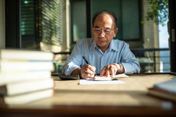 istock Senior accountant working at home 1158850694