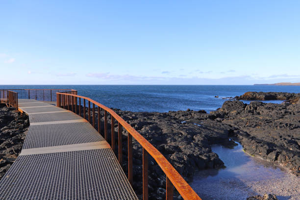 A footpath and viewing platform overlooking Brimketill lava rock pool.