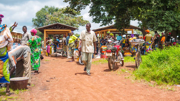 African market scene - Tata Somba, Benin Tata Somba, Benin - Local people trading foods and goods at small villages market. benin stock pictures, royalty-free photos & images