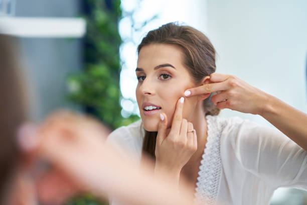 istock Beautiful brunette woman with skin problems in the bathroom 1158852421