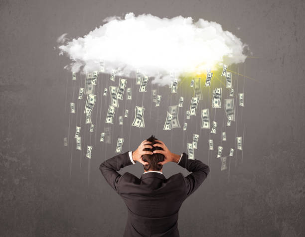 istock Business man in suit looking at cloud with falling money 1158855990