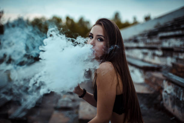 istock young woman vaping vaponizers and clouding 1158856153
